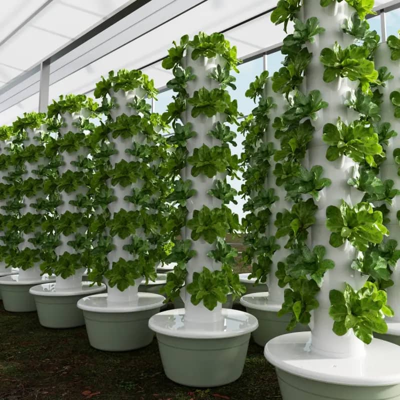 Vertical hydroponic tower with lush greens under grow lighting